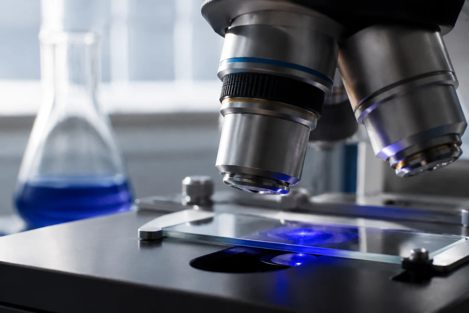 Illustrative pharmaceutical laboratory microscope and glassware